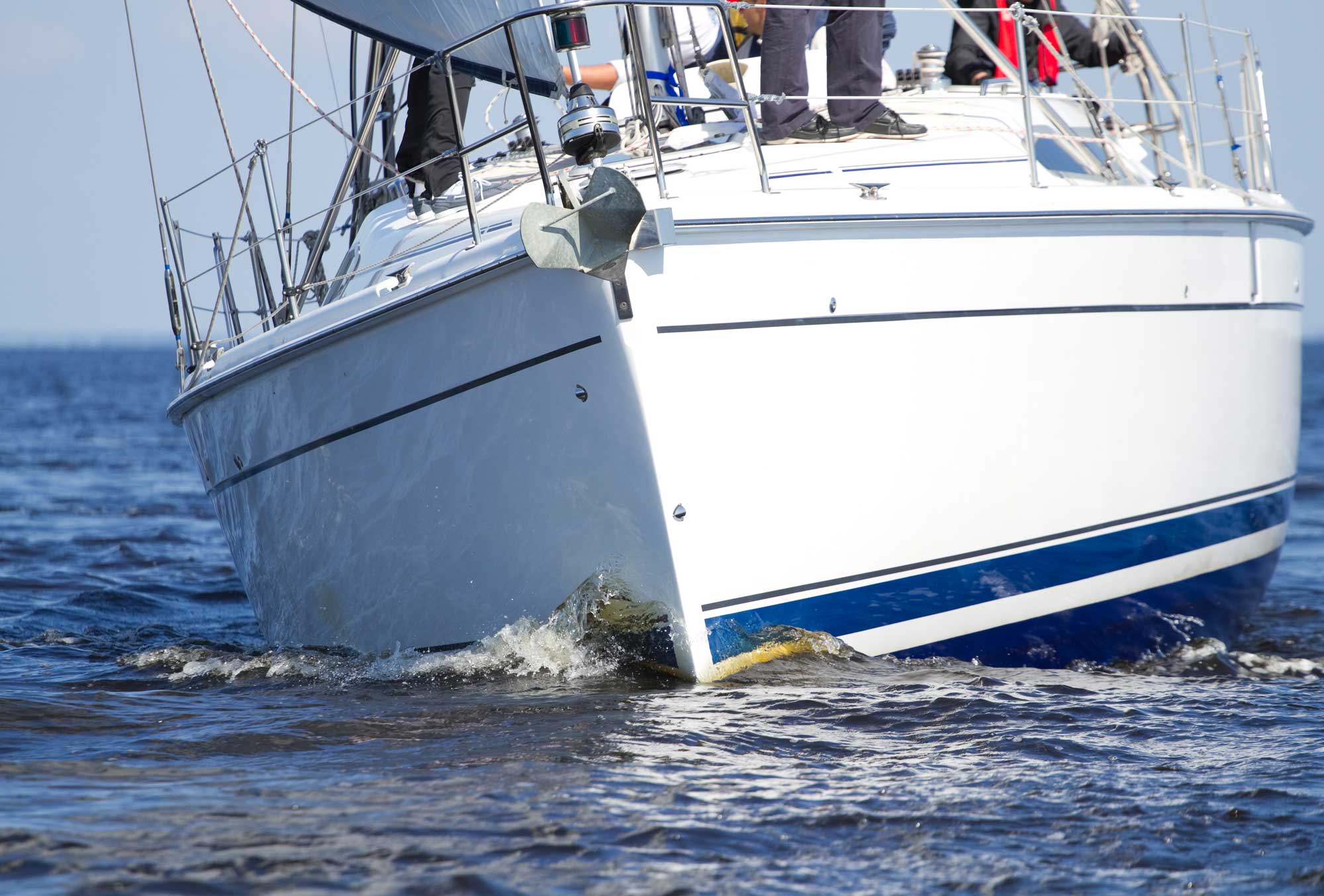 people standing on a sailboat close up view